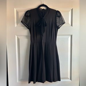 Black fit and flare dress with short sleeves and neck bow